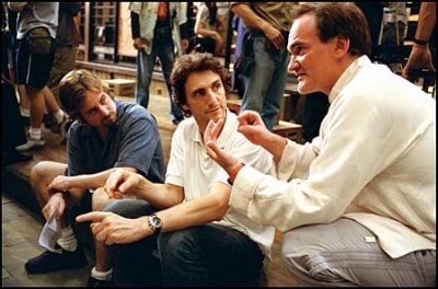 First assistant director Bill Clark, prooducer Lawrence Bender and Quentin Tarantino on the set. The director wants Kill Bill to be an homage to classic martial arts films, down to the right kind of 